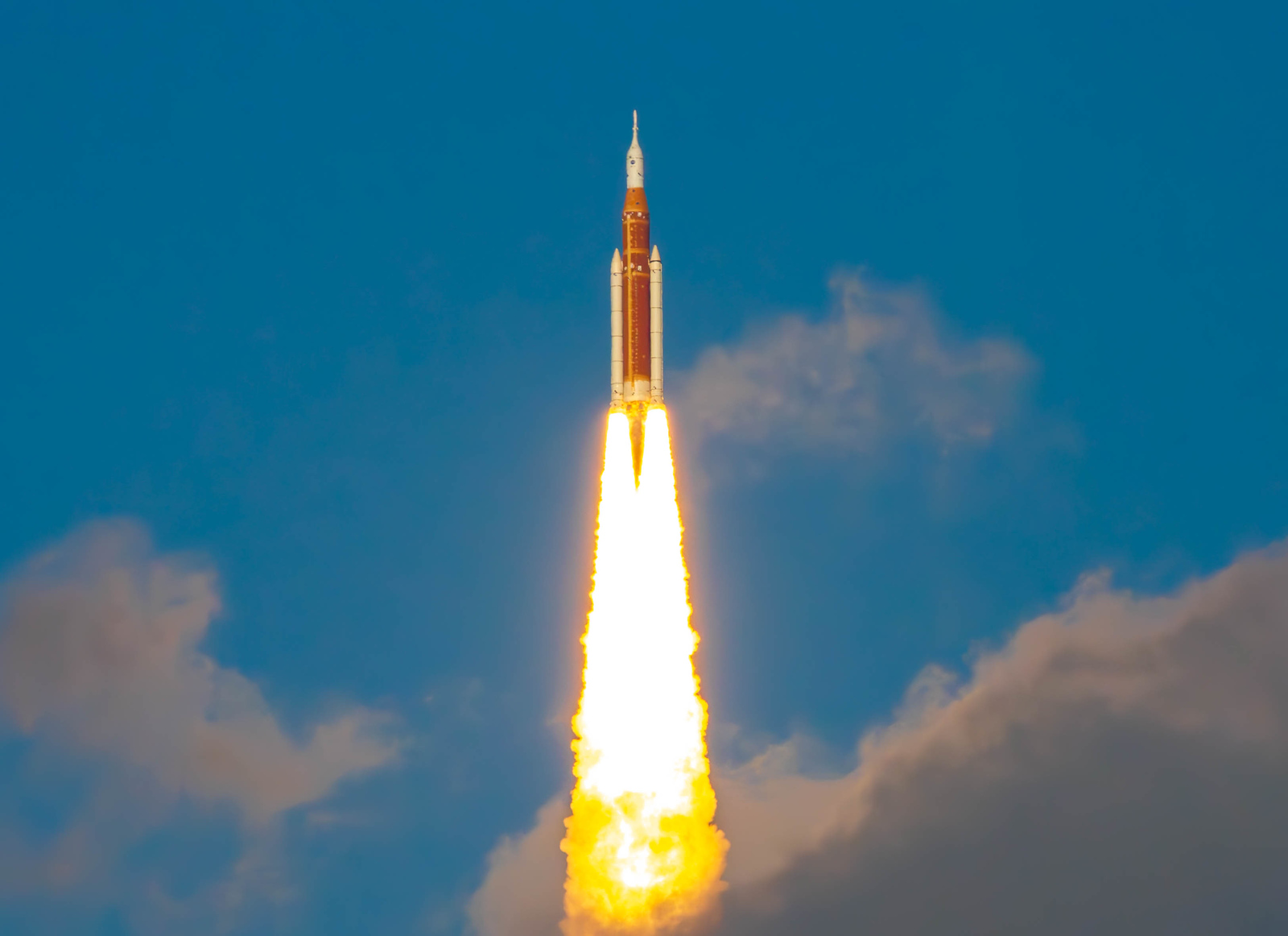 Artemis II rocket lifting off on a column of fire